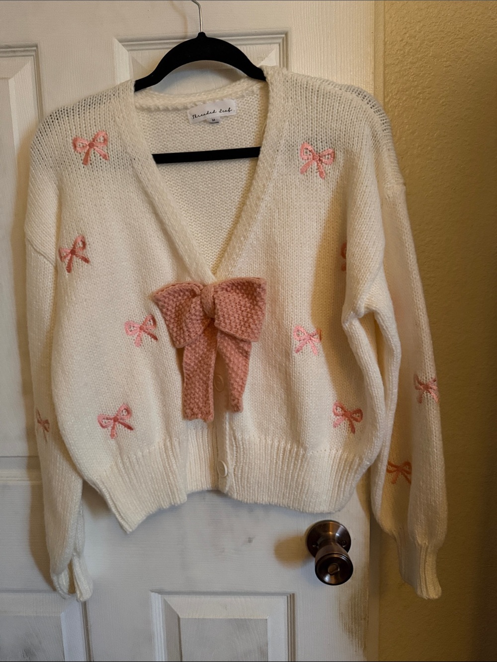 Cream V-Neck Cardigan with Pink Bow Details